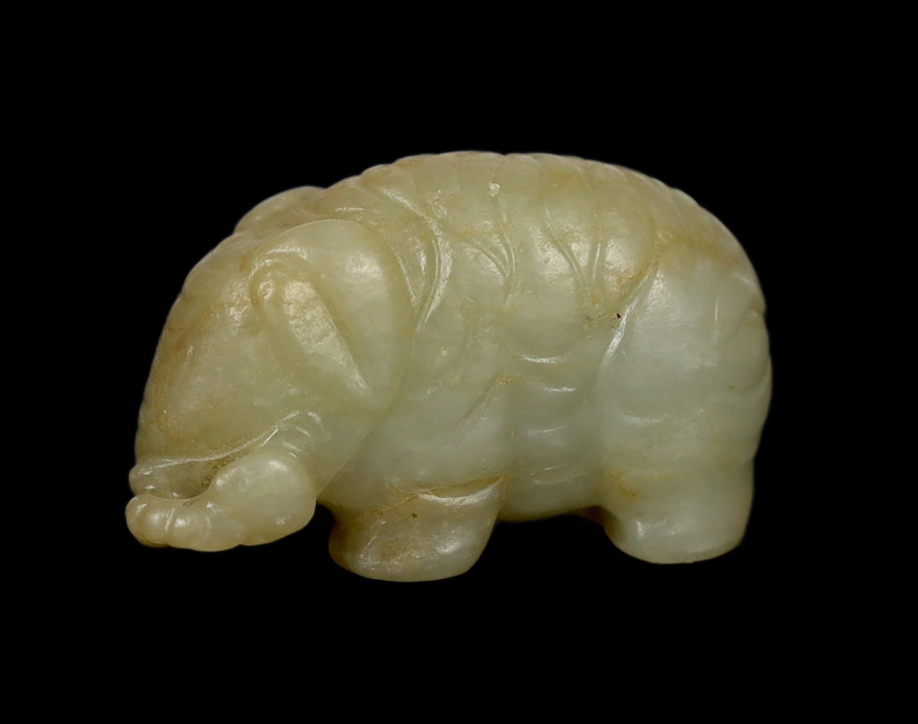 A Chinese small mellow green jade model of a standing elephant, 17th century